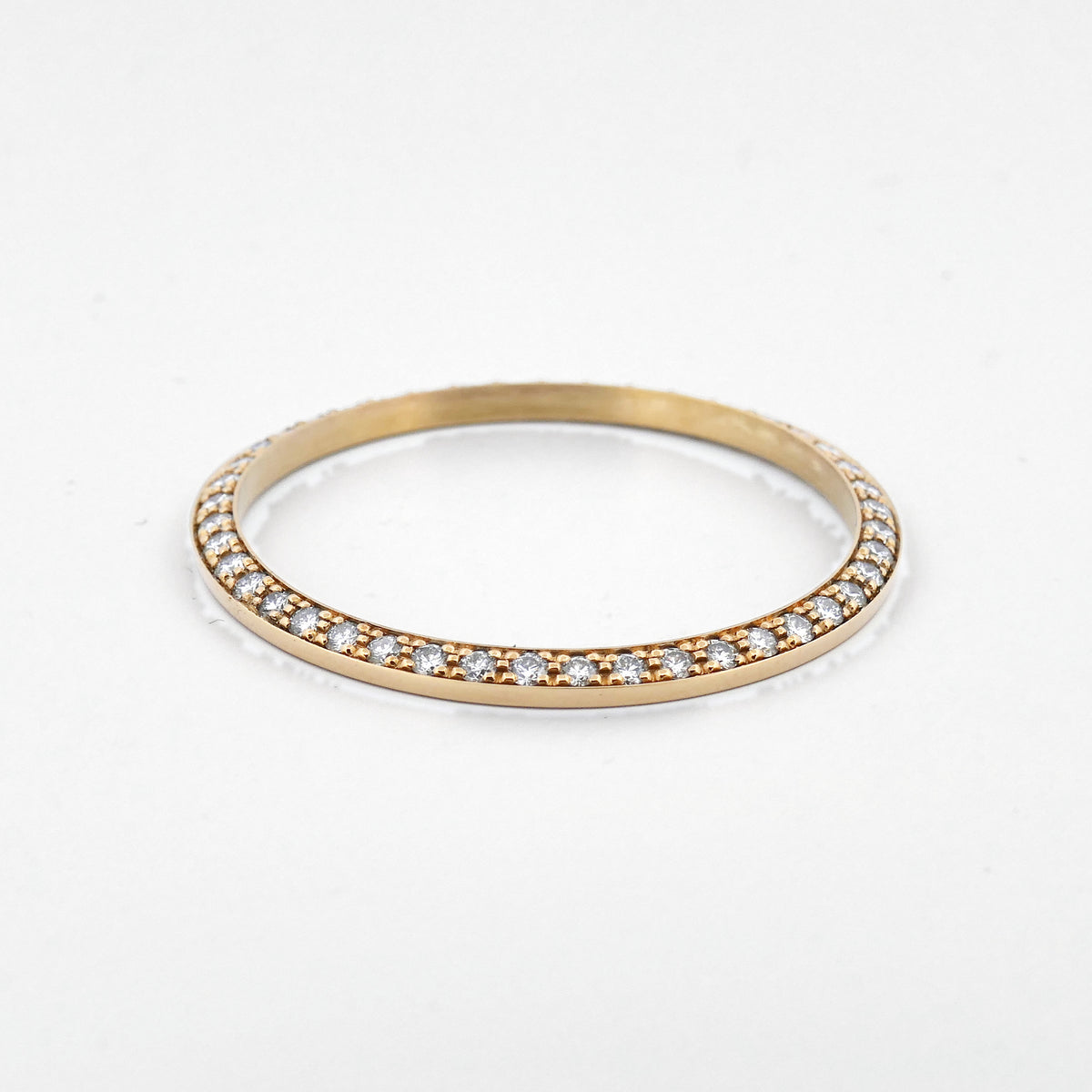 Rolex Day-Date Diamantlünette in Gelbgold liegend, Seitenansicht des Brillantbesatzes